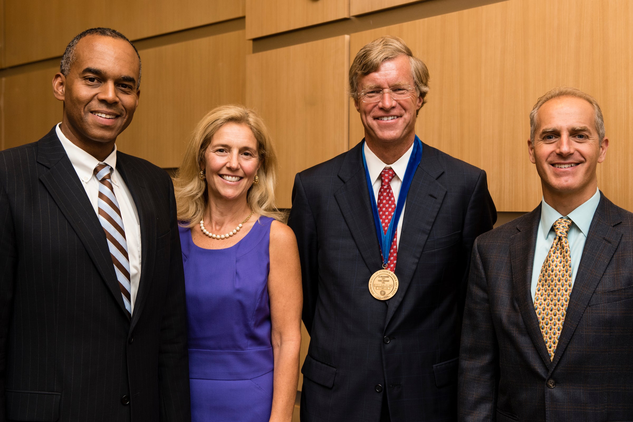 From left: Tufts University Provost David Harris, Christina D Economos, Professor at the Friedman School of Nutrition at Tufts University, Peter R. Dolan, A78, Chair of the Board of Tufts University, and Dariush Mozaffarian, Dean of the Friedman School of Nutrition at Tufts University, pose for a photo together after Dolan was awarded the Friedman School Dean's Medal in recognition to his work on the Child Obesity 180 initiative on September 14, 2016.
