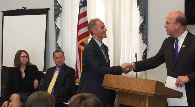 Dean Dariush Mozaffarian pictured shaking the hand of Congressman Jim McGovern